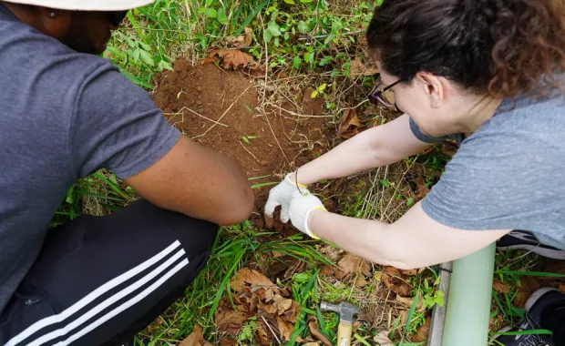 CGI's Senya Dedoo and Theresa White prepare the ground for a tree.