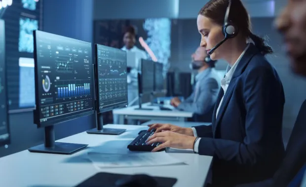 Woman typing on a keyboard in front of a monitor