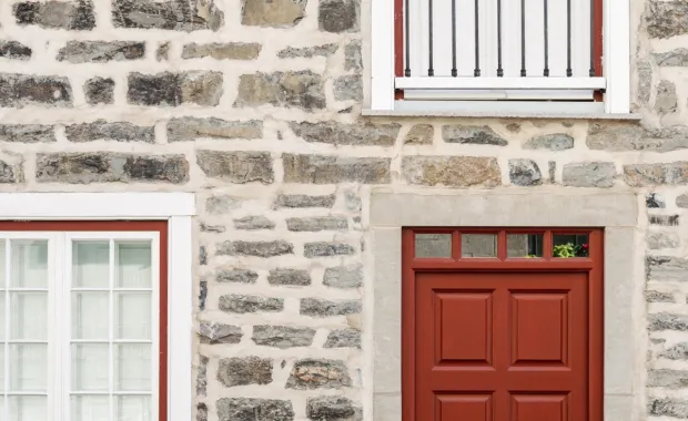 Brick wall with red door and windows