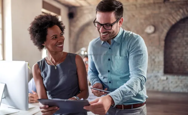 Two business people using a table and talking