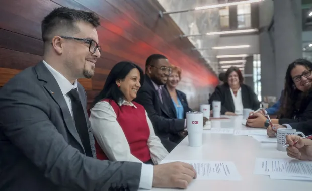CGI Partners smiling sat at desk