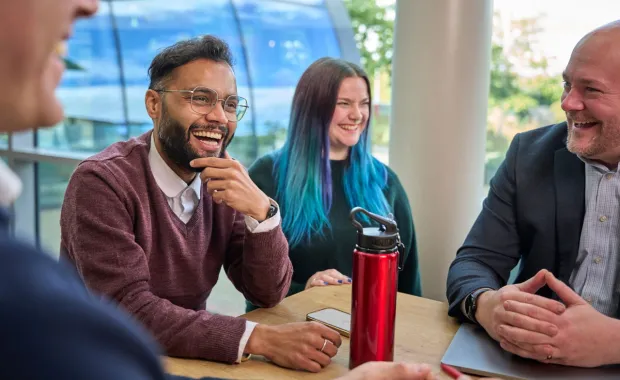 CGI professionals laughing and smiling at work