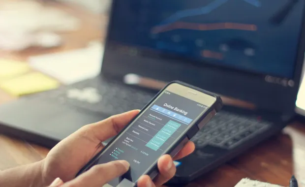 hand using a banking app on a mobile phone