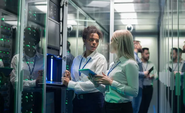 Two professionals reviewing data inside a secure data center