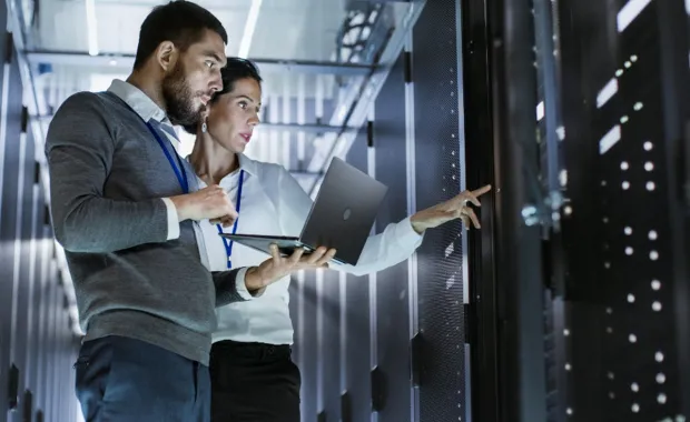 two professionals in a server room