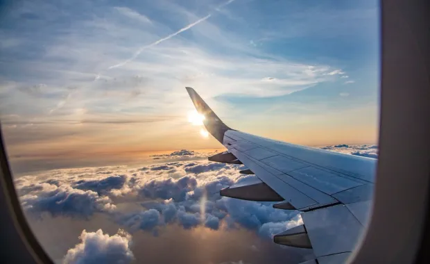 view from an airplane window above the clouds