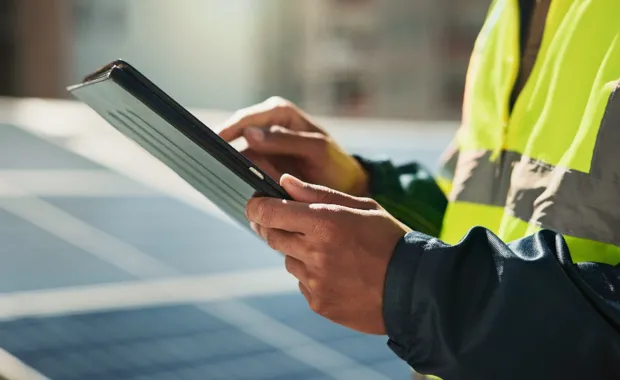 energy professional reviewing data on a tablet
