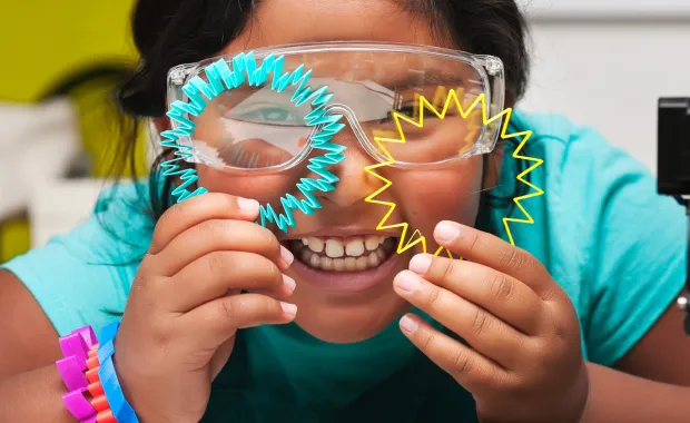 Happy STEM student smiles and shows off the colorful 3d printed shapes
