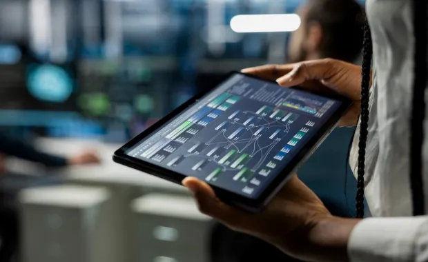 A close-up of data center developer running a simulation on a tablet
