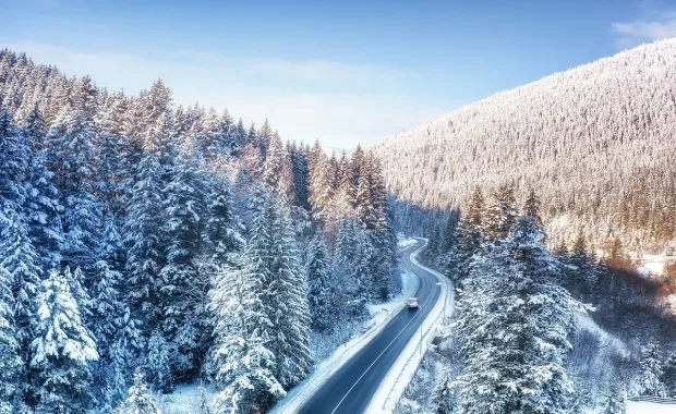 A car on a snowy mountain roadtrip