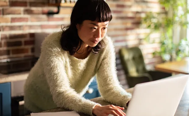 A consultant sitting and working on a laptop