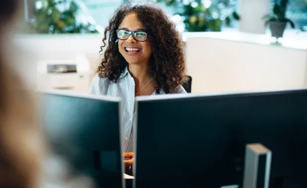 Consultant using Microsoft 365 Copilot on work computer to improve productivity