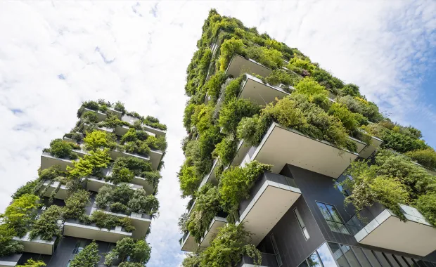 Tall buildings with green plant balconies 