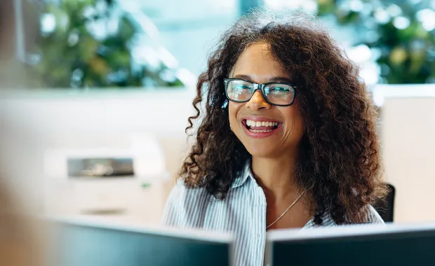 woman at computer smiling
