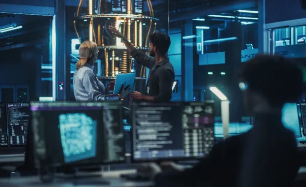 Cyber consultants gesturing to quantum computer