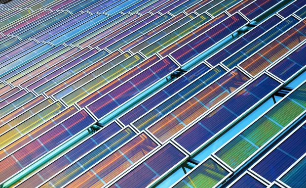 Abstract close-up of overlapping rectangular solar panels arranged in a geometric pattern