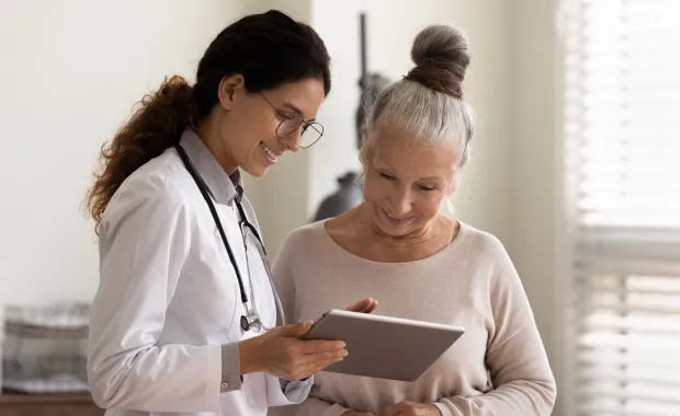 doctor showing patient information on a tablet