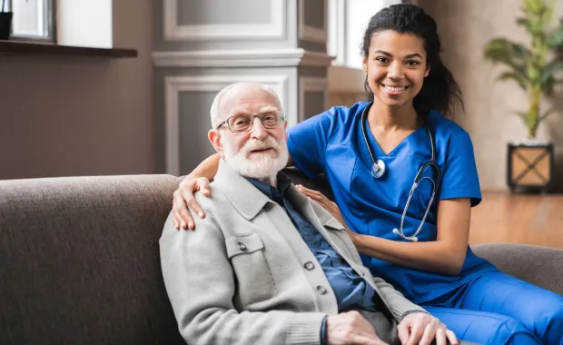 Doctor comforting elderly patient