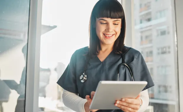 Doctor using tablet device