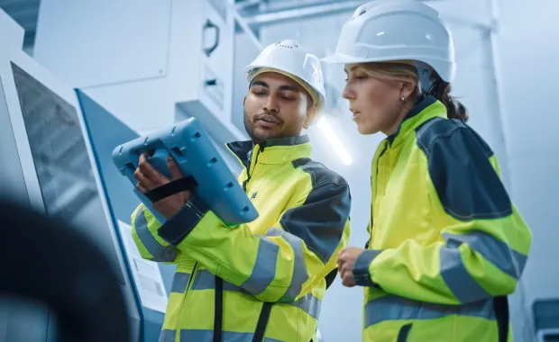 Engineer and project manager working with a tablet
