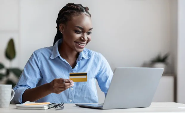 Woman entering payment details on a laptop