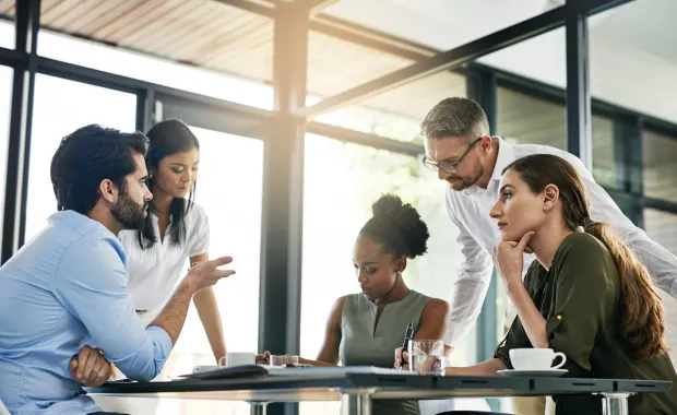 Five professionals in meeting