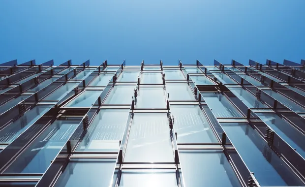 View of glass window panes on a building and blue sky