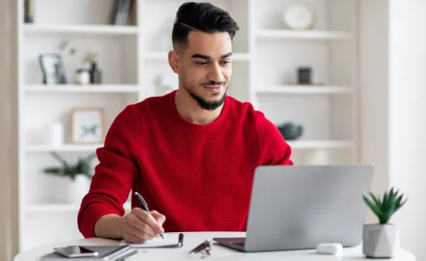 guy with beard works on laptop