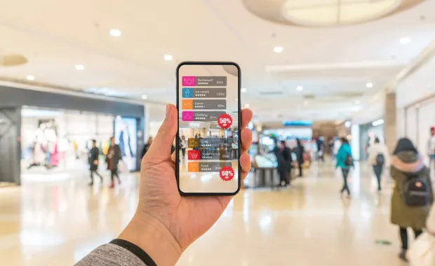 Hand holding smart phone with AR application to check information