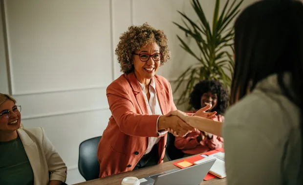 woman shaking the hand of business colleague