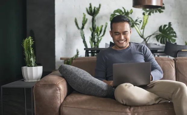 Man with laptop smiling