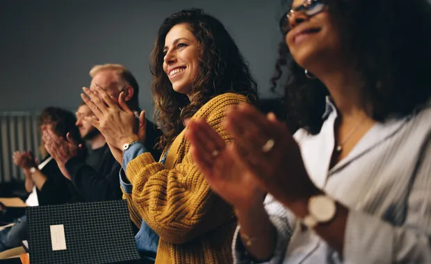 a row of people applauding