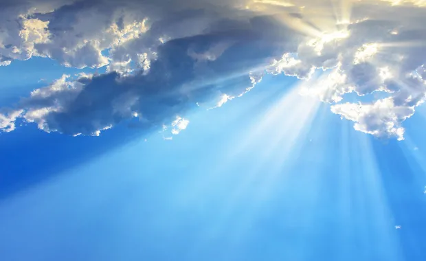 Sunrays through clouds - blue sky
