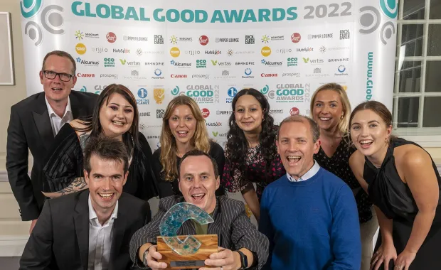 CGI members posing for celebratory photo holding the Global Good Award