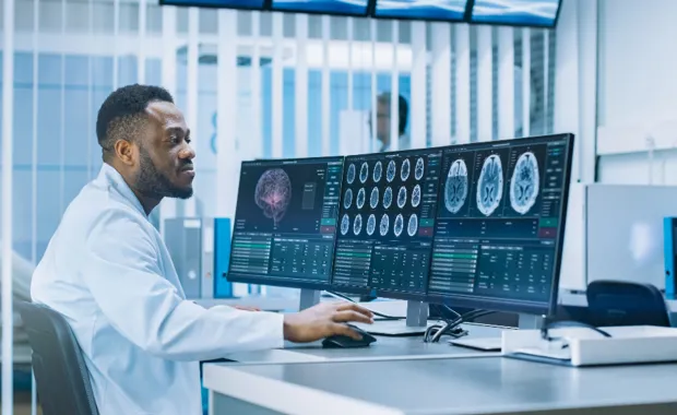 Clinician looking at brains scans on a computer
