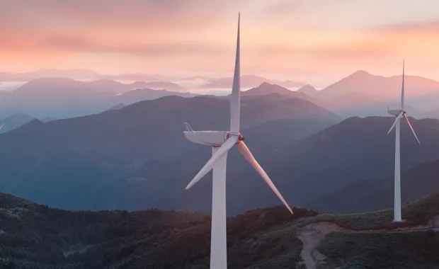 Landscape image of wind farm at sunset