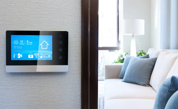 Smart thermostat outside white room