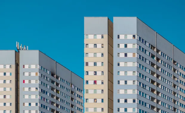 Tower blocks council estate in Camden with a sunny blue sky in the background.