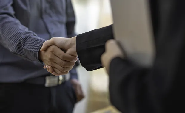 Close up shot of two business people shaking hands
