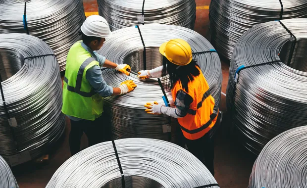 Workers handling rolls of fibre cable ready to be deployed