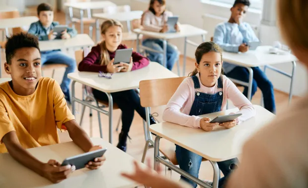 children using tablets in a classroom