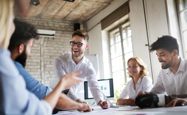 Consultants laughing and talking in a conference room