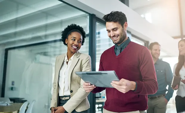 Two partners looking at a tablet 