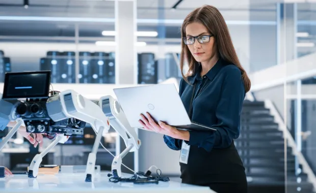 IT programmer working on computer in data center system control room