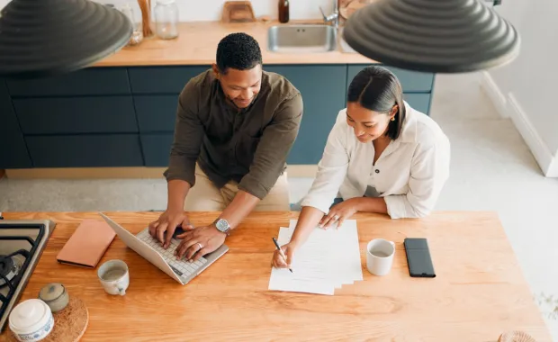 man and woman working on finances