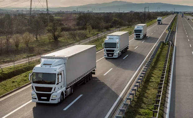 Fleet of lorries driving on a motorway