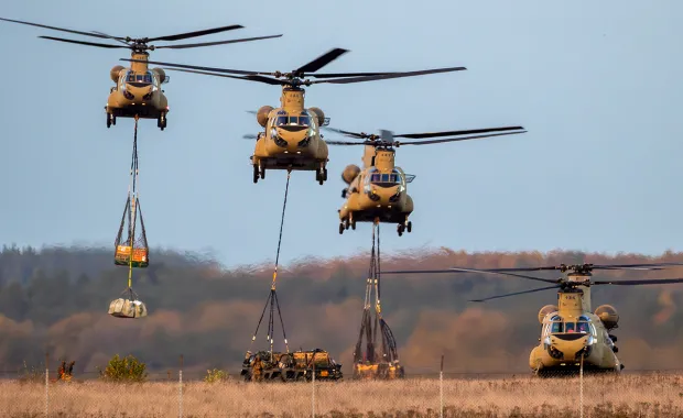 military helicopters picking up supplies