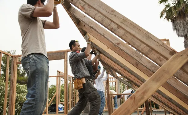 natural disaster recovery workers building a home