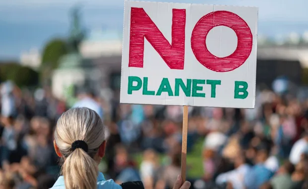 woman holding no planet b placard