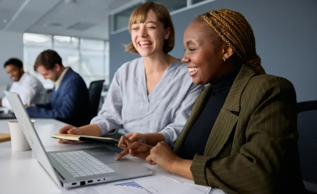 People working together in front of a laptop